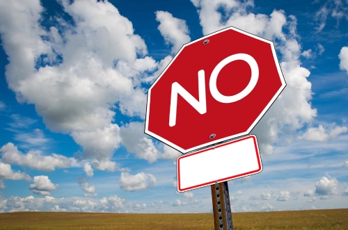 Foto di un segnale di stop con al centro scritto "NO".